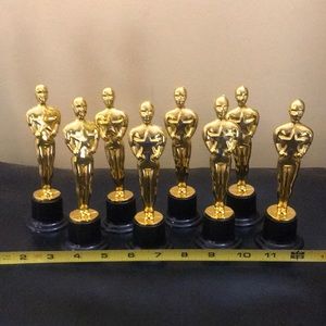 Eight small plastic Oscar decorations.